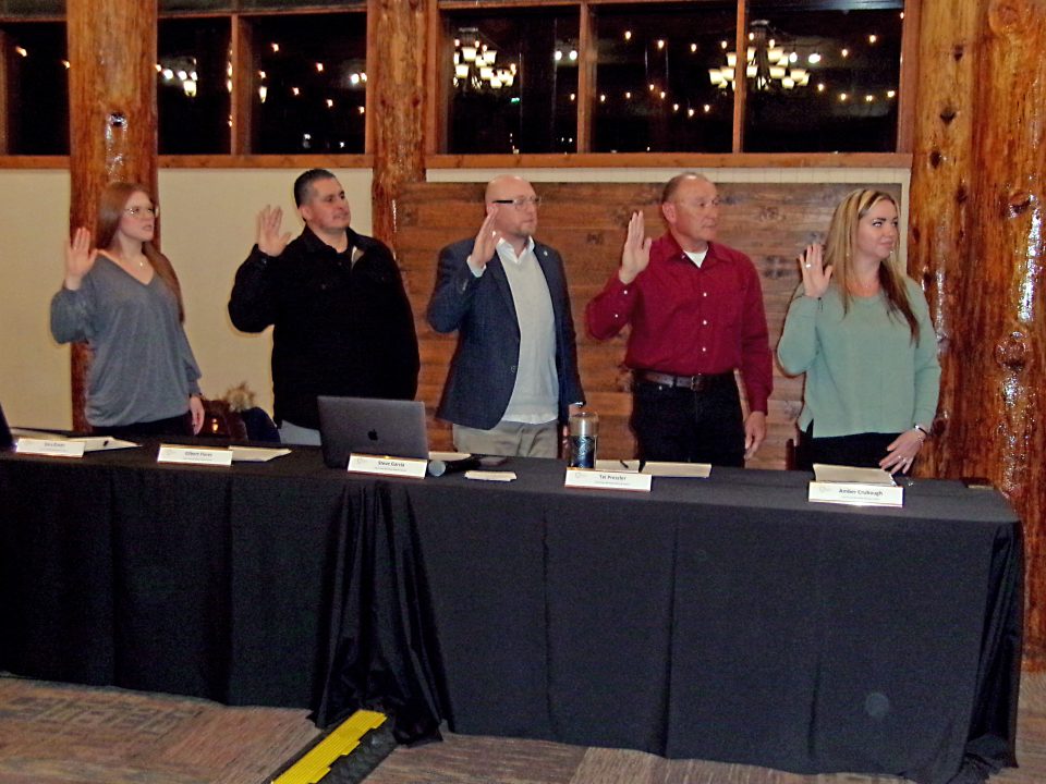 Group taking an oath at a formal event.