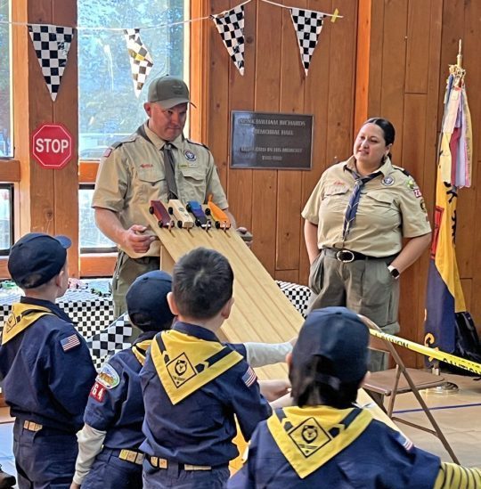 Adrianne, Lisa, Julia, Melissa and Adrianna from Glendora and Orange County enjoyed last year’s Brewfest at Tavern Bay Beach Club so much they couldn’t resist attending this year’s event. (Photos by Douglas W. Motley) Cub Scouts pinewood derby race demonstration indoors.