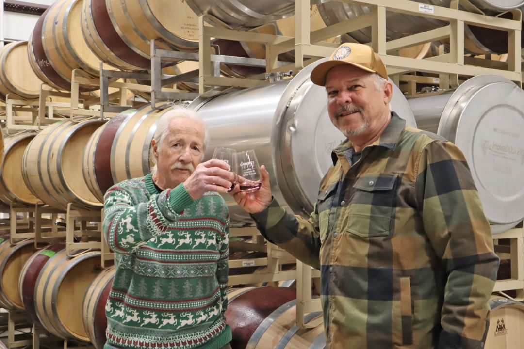 Adrianne, Lisa, Julia, Melissa and Adrianna from Glendora and Orange County enjoyed last year’s Brewfest at Tavern Bay Beach Club so much they couldn’t resist attending this year’s event. (Photos by Douglas W. Motley) Two men toasting in a winery with barrels.