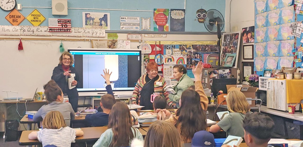 Teacher presenting lesson in colorful classroom.