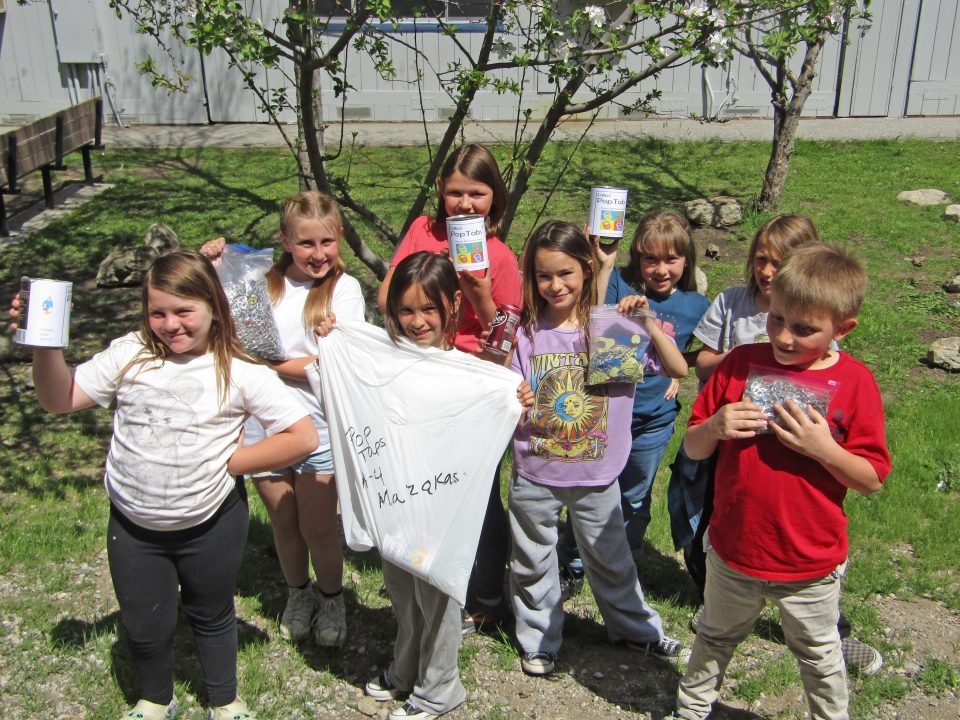 Adrianne, Lisa, Julia, Melissa and Adrianna from Glendora and Orange County enjoyed last year’s Brewfest at Tavern Bay Beach Club so much they couldn’t resist attending this year’s event. (Photos by Douglas W. Motley) Children holding pop tab collection in a park.