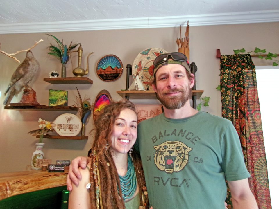Smiling couple in colorful, eclectic room