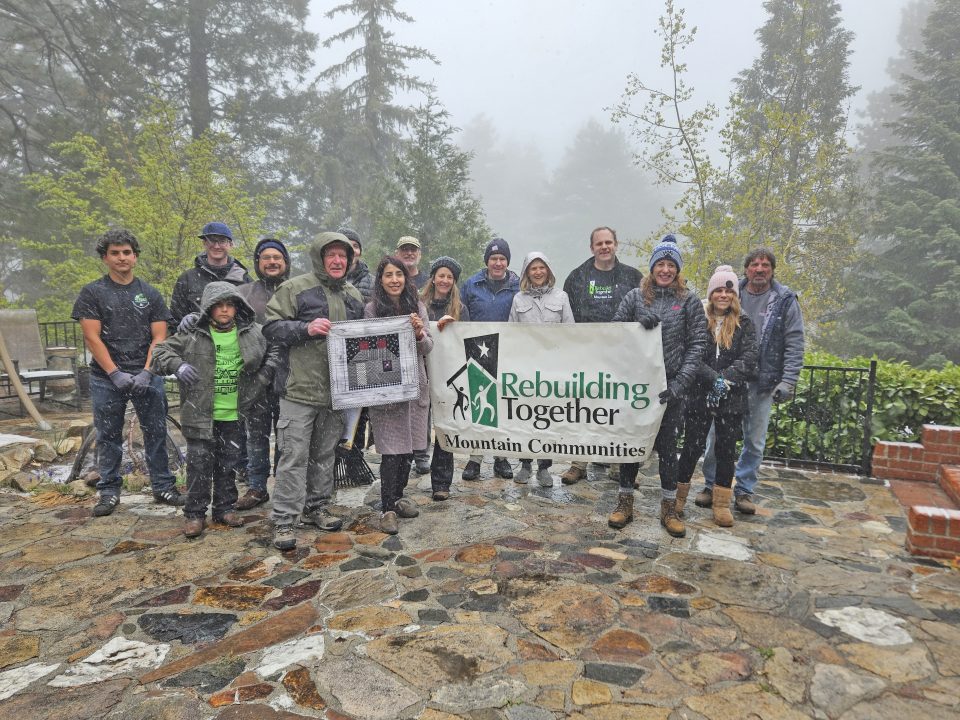 Adrianne, Lisa, Julia, Melissa and Adrianna from Glendora and Orange County enjoyed last year’s Brewfest at Tavern Bay Beach Club so much they couldn’t resist attending this year’s event. (Photos by Douglas W. Motley) Group holding Rebuilding Together sign in snowy forest.