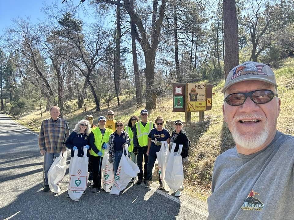 Group of volunteers cleaning up roadside
