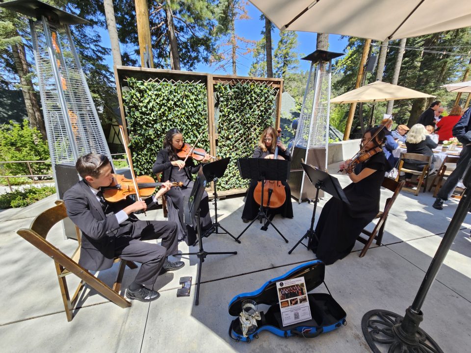Adrianne, Lisa, Julia, Melissa and Adrianna from Glendora and Orange County enjoyed last year’s Brewfest at Tavern Bay Beach Club so much they couldn’t resist attending this year’s event. (Photos by Douglas W. Motley) String quartet performing outdoors at an event.