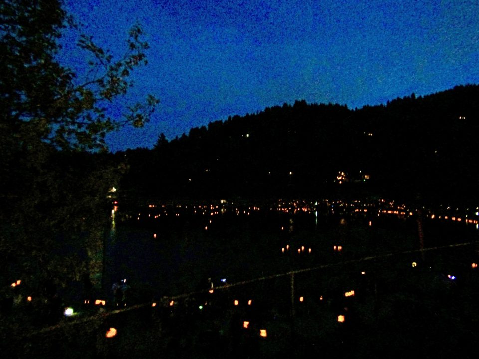 Lanterns float on lake at night