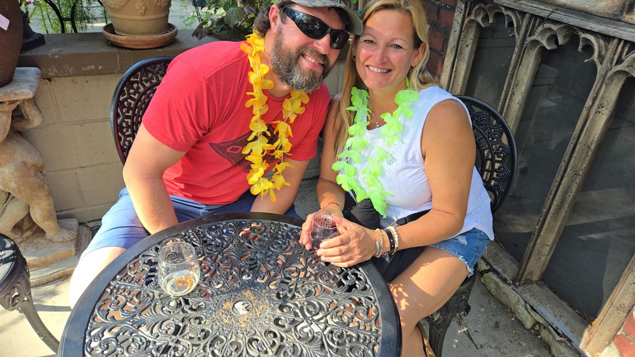 Adrianne, Lisa, Julia, Melissa and Adrianna from Glendora and Orange County enjoyed last year’s Brewfest at Tavern Bay Beach Club so much they couldn’t resist attending this year’s event. (Photos by Douglas W. Motley) Smiling couple with leis sitting outdoors.