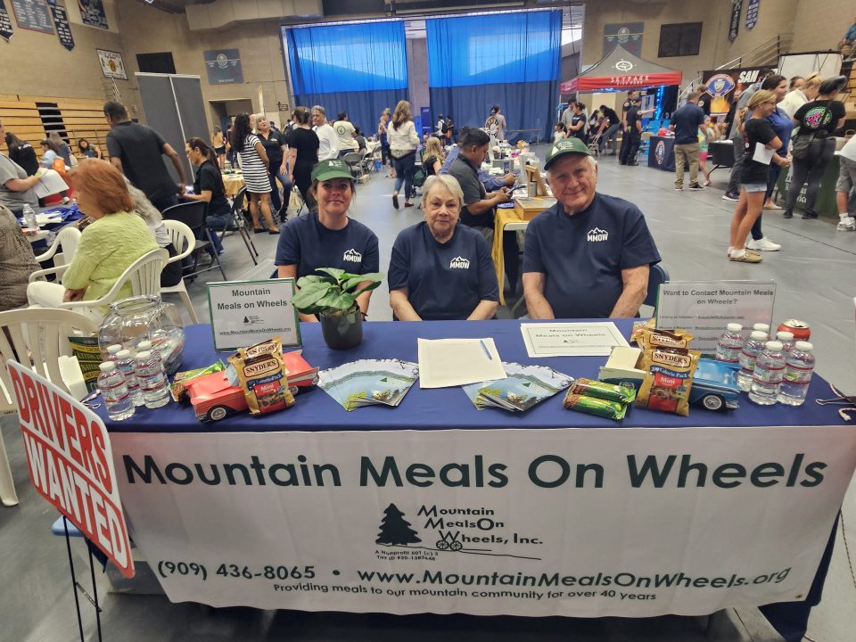 Adrianne, Lisa, Julia, Melissa and Adrianna from Glendora and Orange County enjoyed last year’s Brewfest at Tavern Bay Beach Club so much they couldn’t resist attending this year’s event. (Photos by Douglas W. Motley) Volunteers at Mountain Meals on Wheels event table.