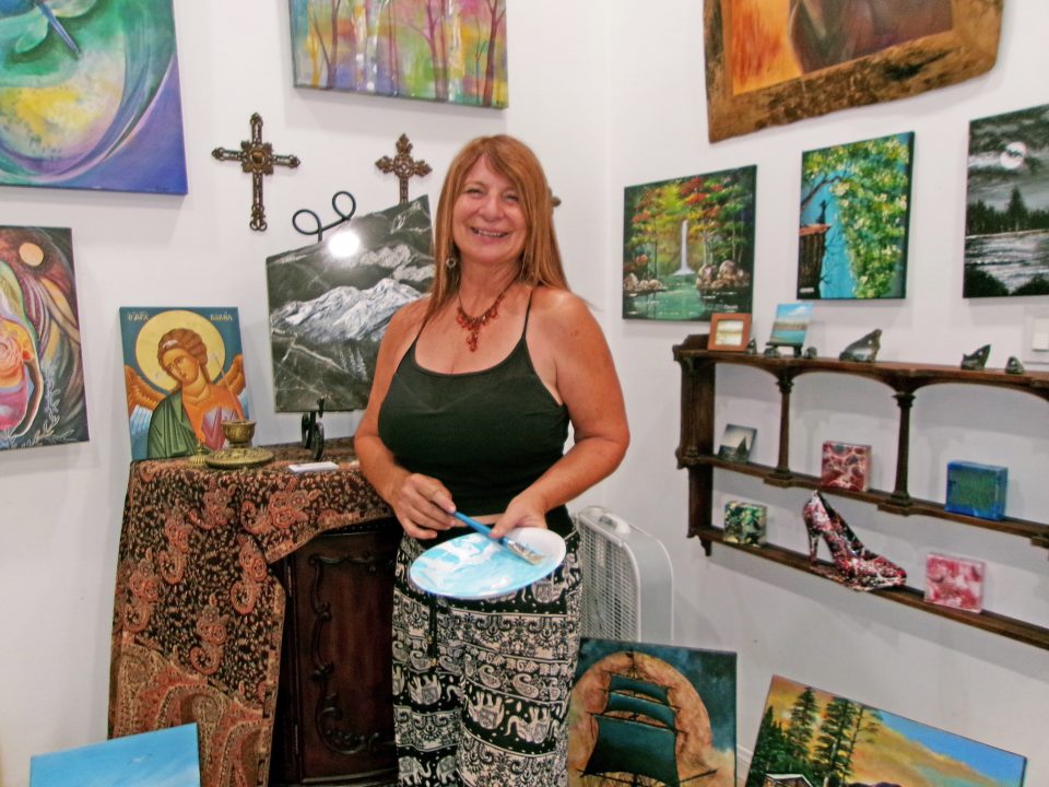 Adrianne, Lisa, Julia, Melissa and Adrianna from Glendora and Orange County enjoyed last year’s Brewfest at Tavern Bay Beach Club so much they couldn’t resist attending this year’s event. (Photos by Douglas W. Motley) Artist smiling in studio with paintings on wall.