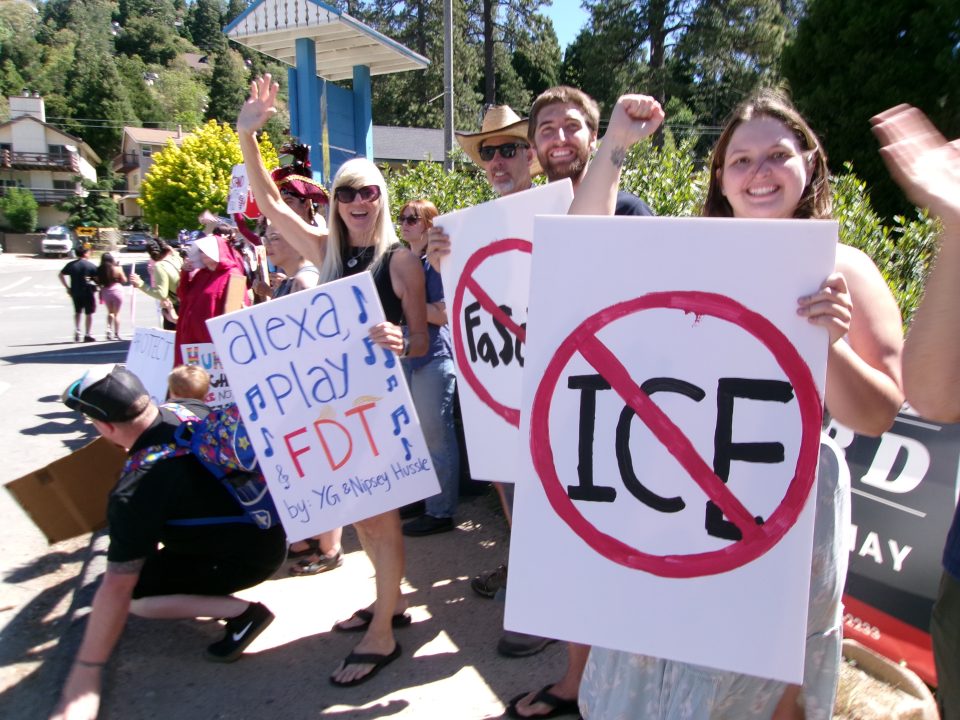 Protesters holding anti-ICE and music request signs