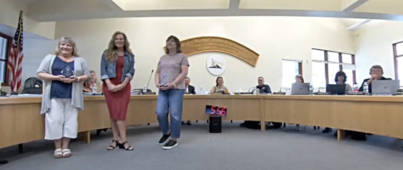 Adrianne, Lisa, Julia, Melissa and Adrianna from Glendora and Orange County enjoyed last year’s Brewfest at Tavern Bay Beach Club so much they couldn’t resist attending this year’s event. (Photos by Douglas W. Motley) Three women receive awards at a board meeting.
