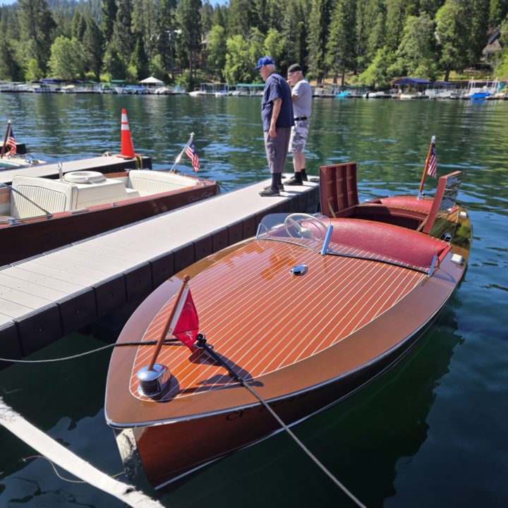 Adrianne, Lisa, Julia, Melissa and Adrianna from Glendora and Orange County enjoyed last year’s Brewfest at Tavern Bay Beach Club so much they couldn’t resist attending this year’s event. (Photos by Douglas W. Motley) Vintage boat docked on a scenic lake