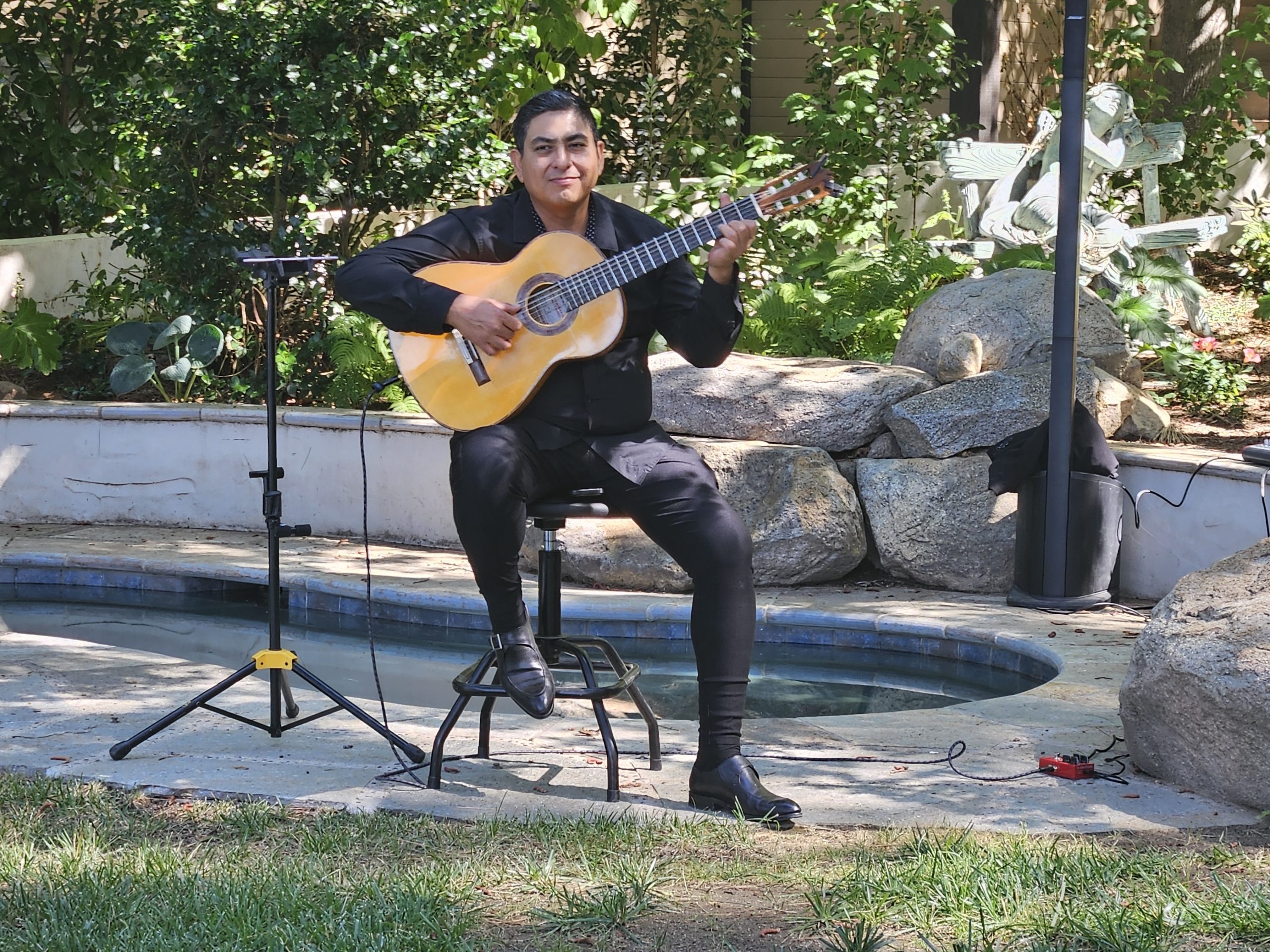 Adrianne, Lisa, Julia, Melissa and Adrianna from Glendora and Orange County enjoyed last year’s Brewfest at Tavern Bay Beach Club so much they couldn’t resist attending this year’s event. (Photos by Douglas W. Motley) Man playing acoustic guitar outdoors by a pool.