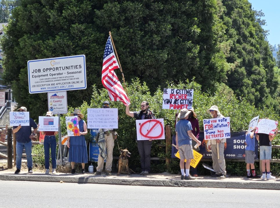 Adrianne, Lisa, Julia, Melissa and Adrianna from Glendora and Orange County enjoyed last year’s Brewfest at Tavern Bay Beach Club so much they couldn’t resist attending this year’s event. (Photos by Douglas W. Motley) Protesters with signs near job opportunities signpost.