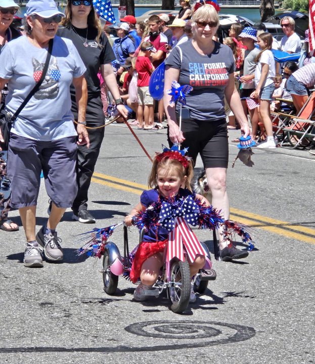 Adrianne, Lisa, Julia, Melissa and Adrianna from Glendora and Orange County enjoyed last year’s Brewfest at Tavern Bay Beach Club so much they couldn’t resist attending this year’s event. (Photos by Douglas W. Motley) Child in parade with patriotic decorations and tricycle