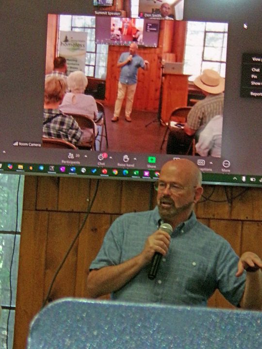 Speaker delivers presentation at conference via video call.
