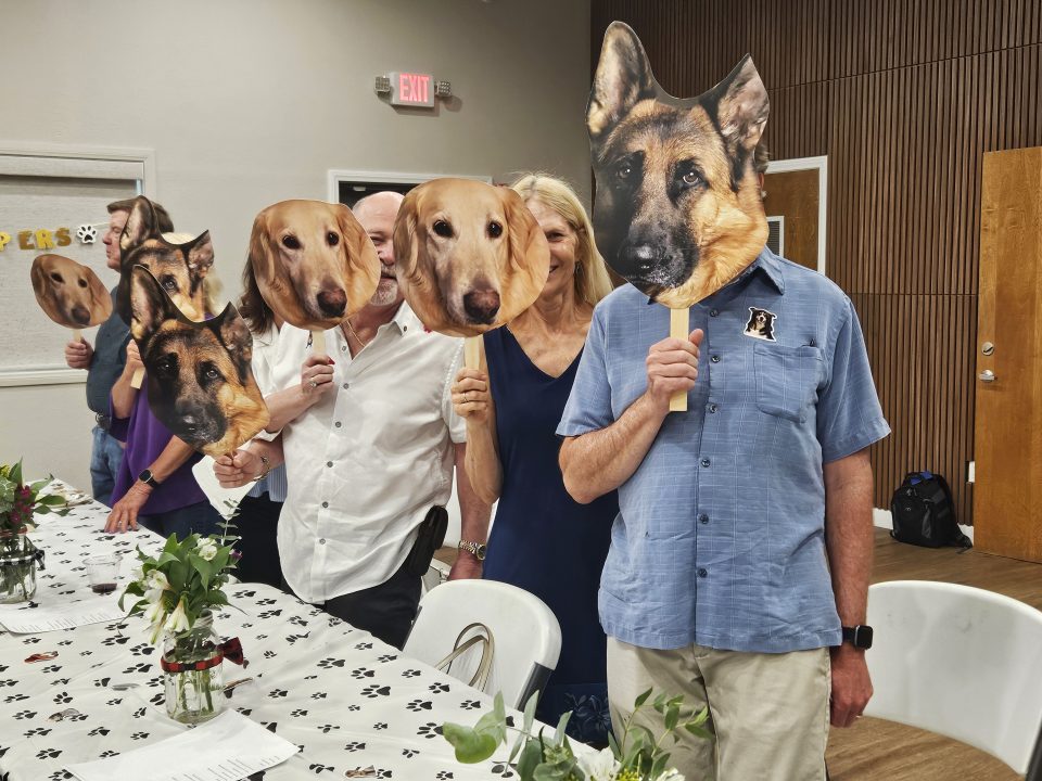 Adrianne, Lisa, Julia, Melissa and Adrianna from Glendora and Orange County enjoyed last year’s Brewfest at Tavern Bay Beach Club so much they couldn’t resist attending this year’s event. (Photos by Douglas W. Motley) People holding large dog face masks at table.