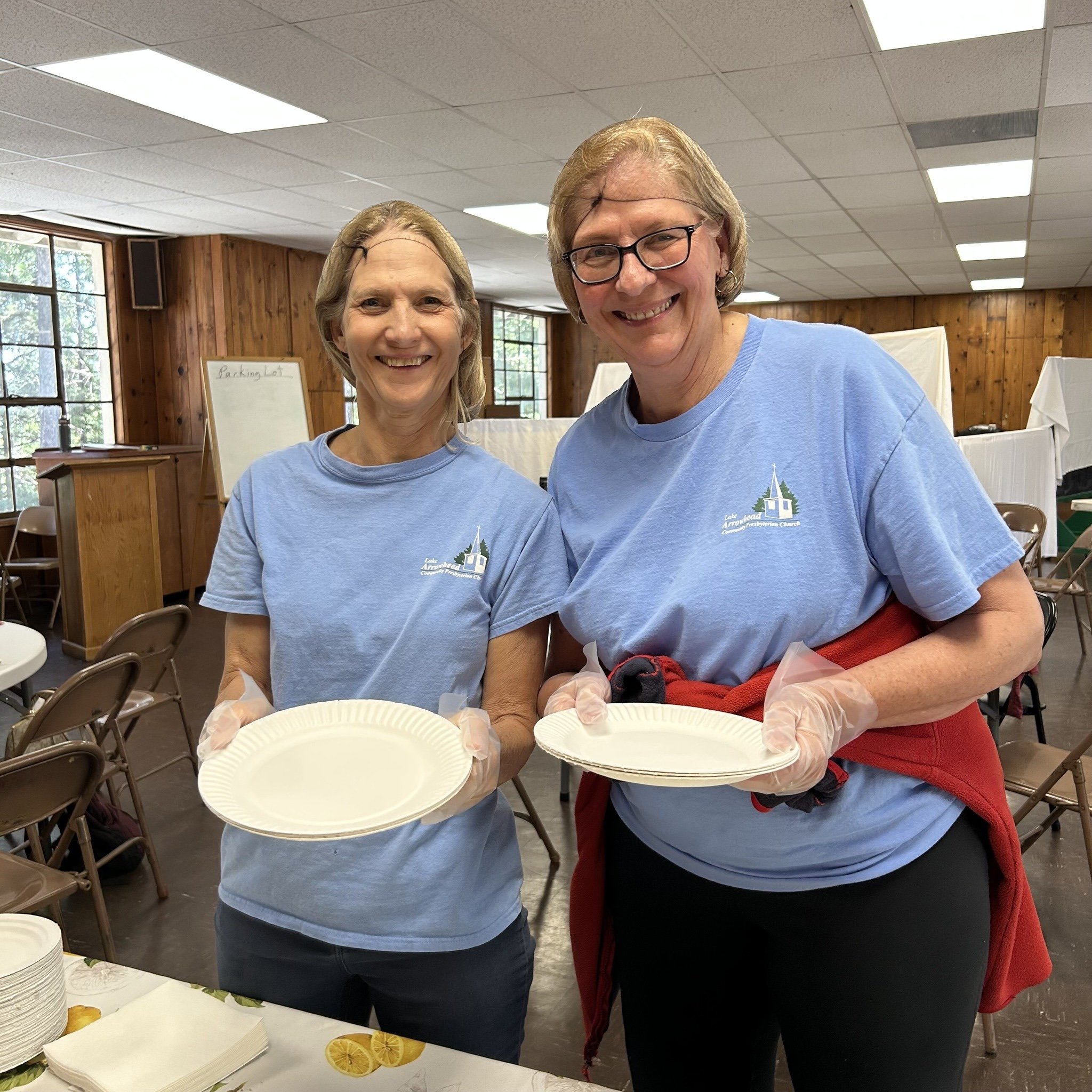 Adrianne, Lisa, Julia, Melissa and Adrianna from Glendora and Orange County enjoyed last year’s Brewfest at Tavern Bay Beach Club so much they couldn’t resist attending this year’s event. (Photos by Douglas W. Motley) Volunteers smiling with paper plates in community center.