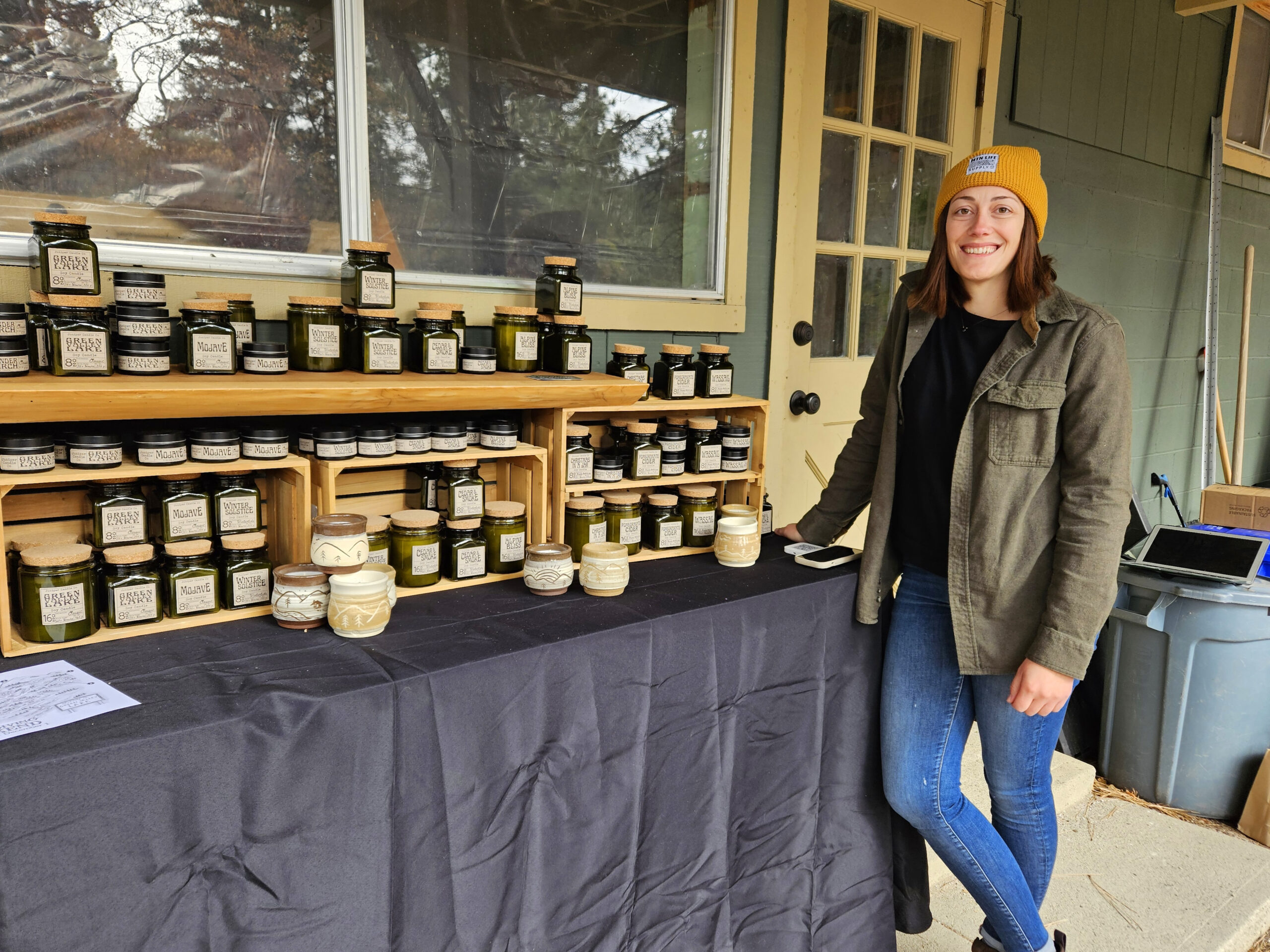 Adrianne, Lisa, Julia, Melissa and Adrianna from Glendora and Orange County enjoyed last year’s Brewfest at Tavern Bay Beach Club so much they couldn’t resist attending this year’s event. (Photos by Douglas W. Motley) Person selling artisanal candles at outdoor market.