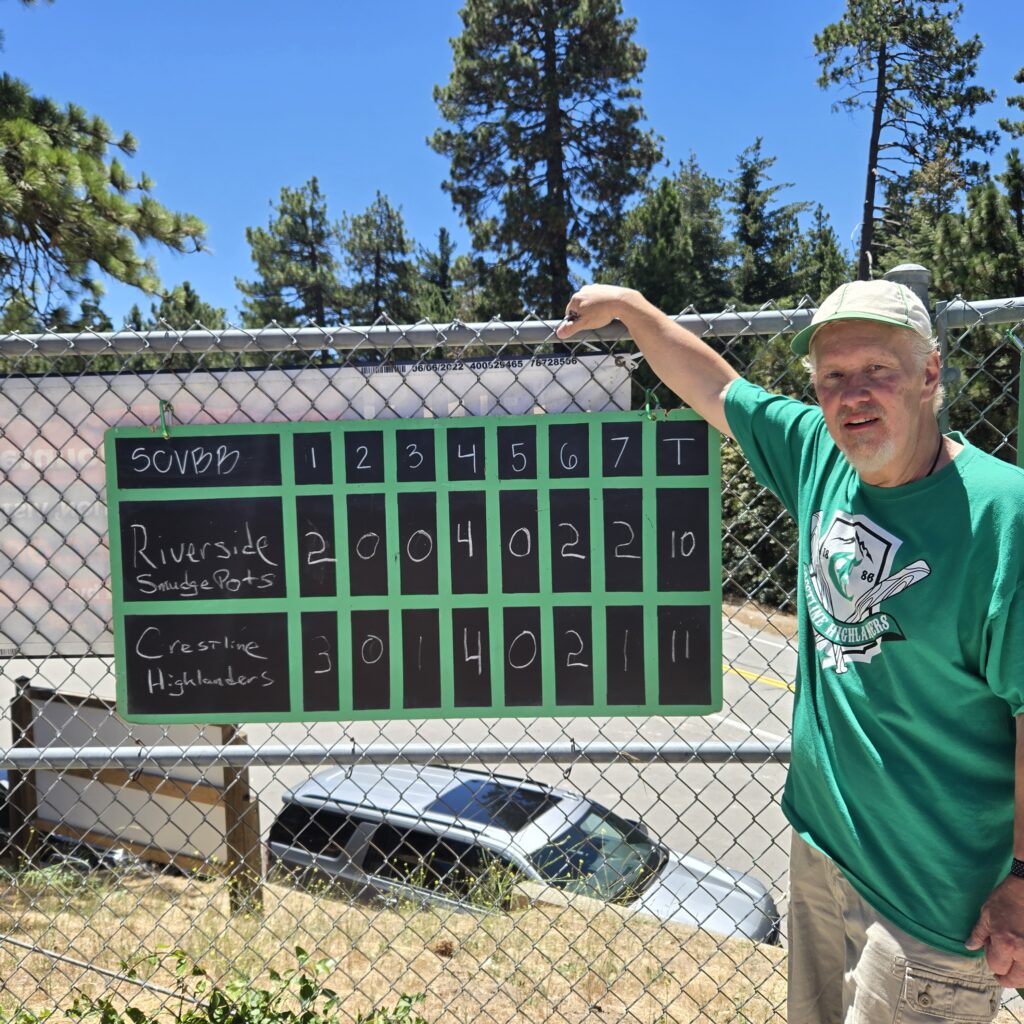 team captain chris dodd aka glovebox shows the scoreboard of the highlanders’ win over the riverside smudgepots. (photos by douglas w. motley)