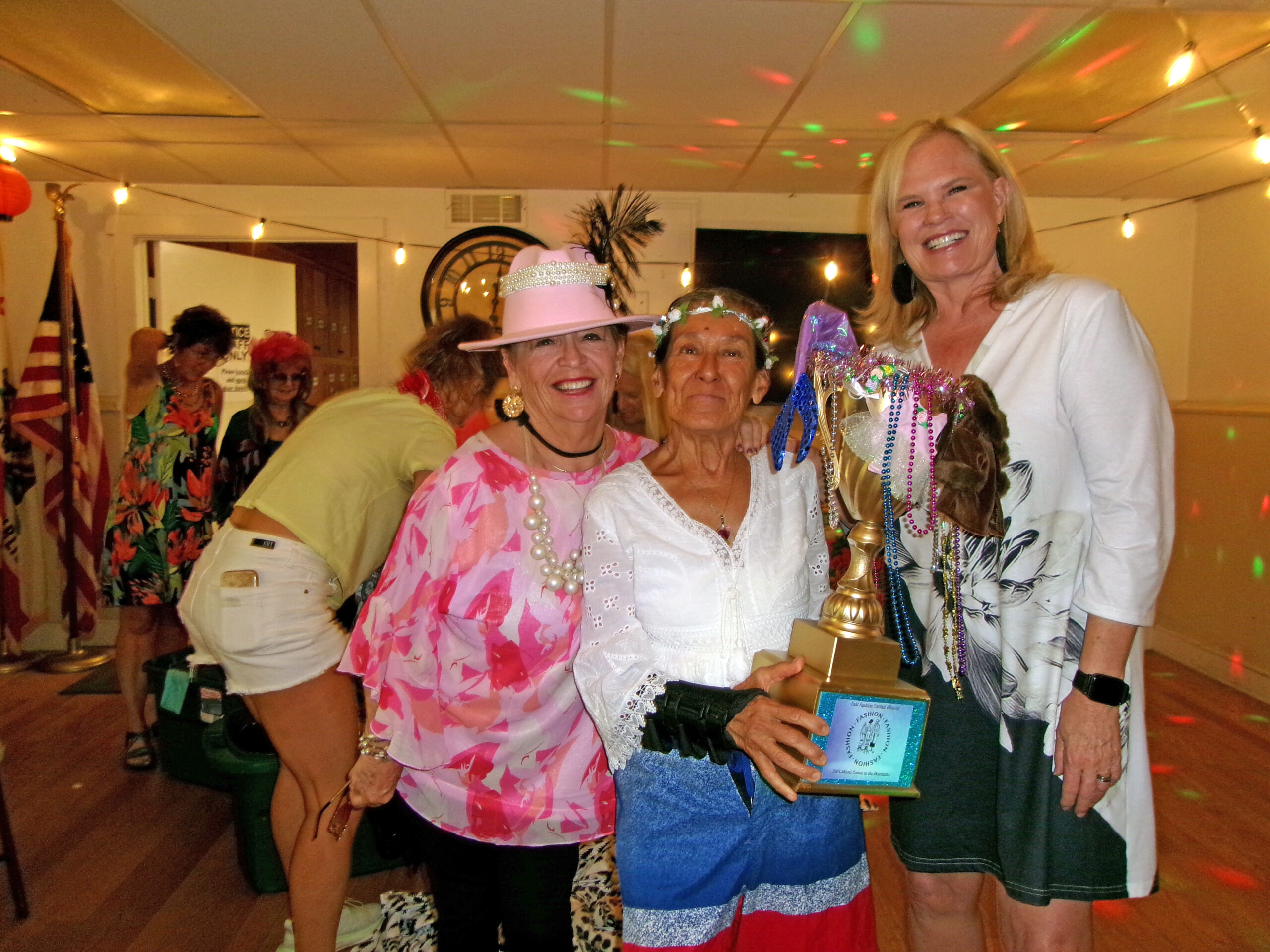 Adrianne, Lisa, Julia, Melissa and Adrianna from Glendora and Orange County enjoyed last year’s Brewfest at Tavern Bay Beach Club so much they couldn’t resist attending this year’s event. (Photos by Douglas W. Motley) Group celebrating with trophy at festive event.