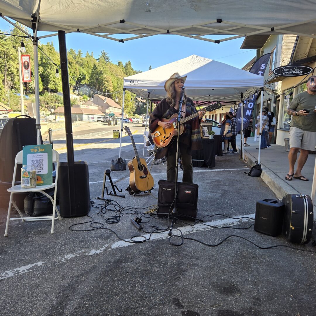 Adrianne, Lisa, Julia, Melissa and Adrianna from Glendora and Orange County enjoyed last year’s Brewfest at Tavern Bay Beach Club so much they couldn’t resist attending this year’s event. (Photos by Douglas W. Motley) Street musician playing guitar at outdoor market.