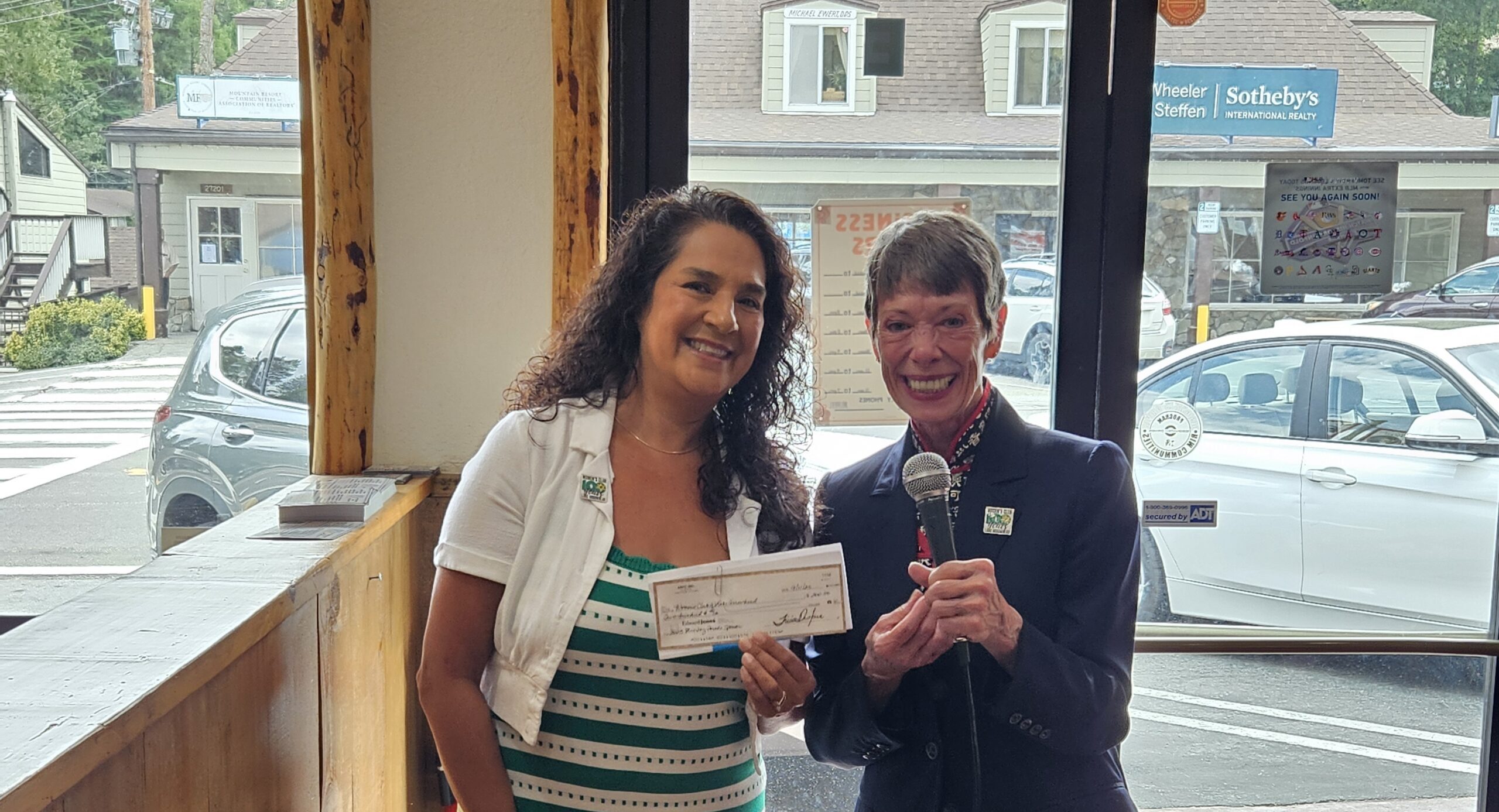 Adrianne, Lisa, Julia, Melissa and Adrianna from Glendora and Orange County enjoyed last year’s Brewfest at Tavern Bay Beach Club so much they couldn’t resist attending this year’s event. (Photos by Douglas W. Motley) Two people smiling, holding a check indoors.