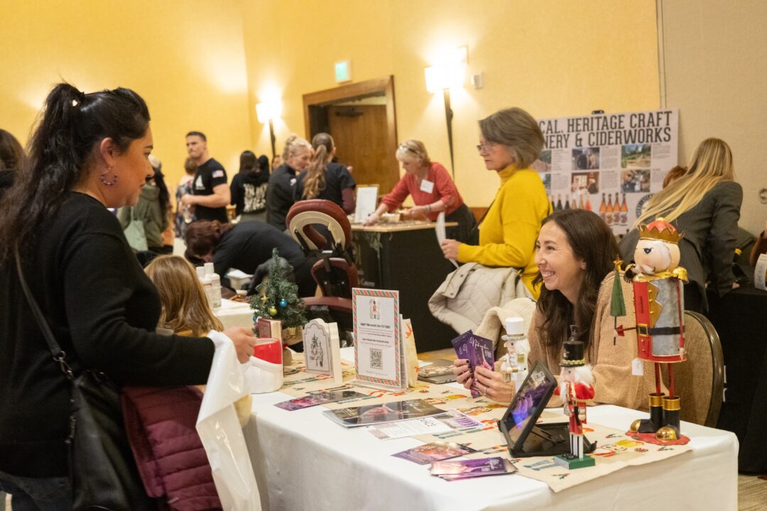 Adrianne, Lisa, Julia, Melissa and Adrianna from Glendora and Orange County enjoyed last year’s Brewfest at Tavern Bay Beach Club so much they couldn’t resist attending this year’s event. (Photos by Douglas W. Motley) People interacting at craft fair table display