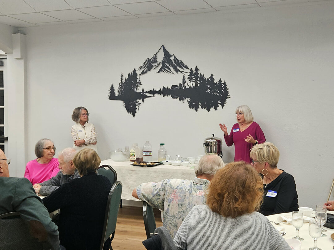 Adrianne, Lisa, Julia, Melissa and Adrianna from Glendora and Orange County enjoyed last year’s Brewfest at Tavern Bay Beach Club so much they couldn’t resist attending this year’s event. (Photos by Douglas W. Motley) Seniors gathering with speaker indoors near mountain artwork.