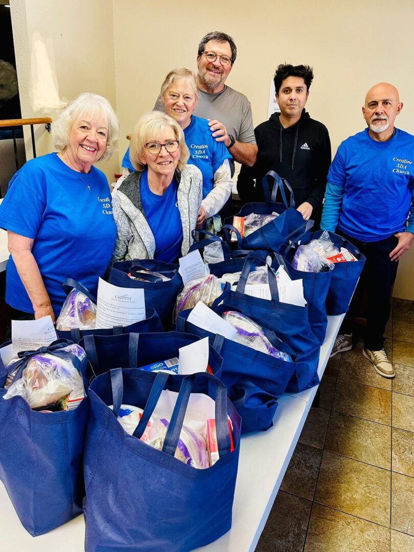 Volunteers with blue bags of donated food items.