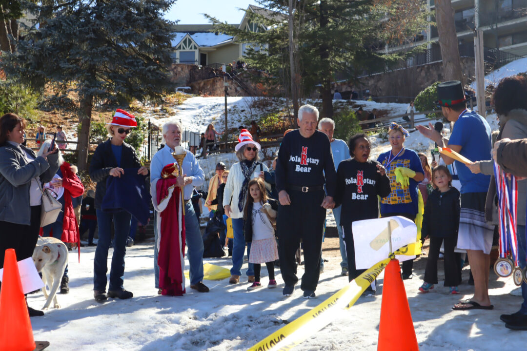 The king and queen of the Plunge – Patrick and Jo Bonita Rains – emerge from the chilly waters of the lake. (File photos)
