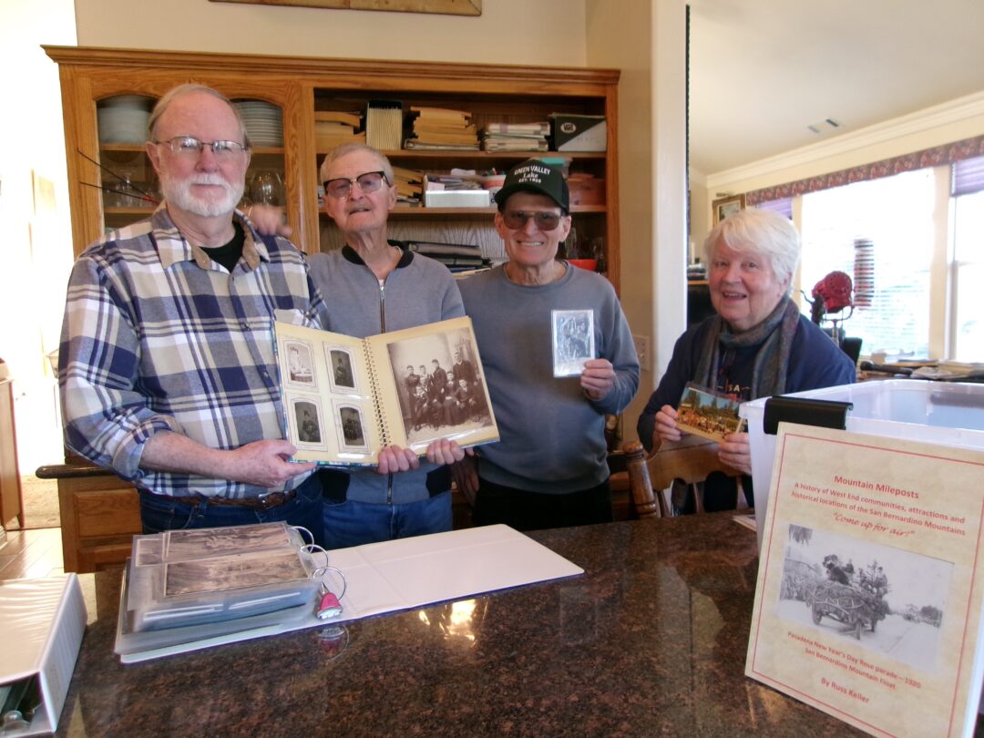 Adrianne, Lisa, Julia, Melissa and Adrianna from Glendora and Orange County enjoyed last year’s Brewfest at Tavern Bay Beach Club so much they couldn’t resist attending this year’s event. (Photos by Douglas W. Motley) Pat Huckaby, Russ Keller, Dennis Foster and Sandy Huckaby examine Keller’s photo albums on Green Valley Lake’s history. (Photo by Rhea-Frances Tetley)