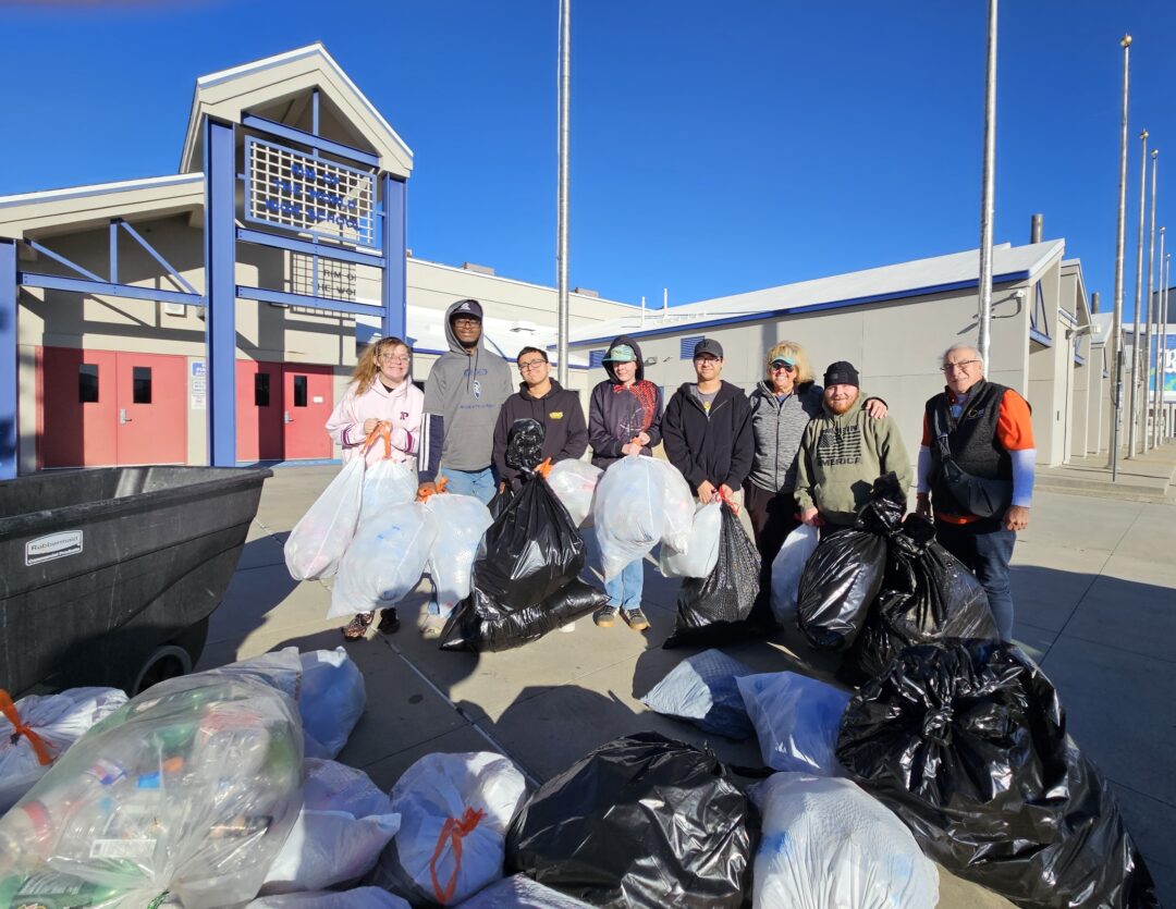 Rotarians Armand LeSage (far right) and Jill Neumen (third from right) with the Awesome Learners and the recyclables the students will turn into Burrtec for cash. (Photo by Mary-Justine Lanyon)