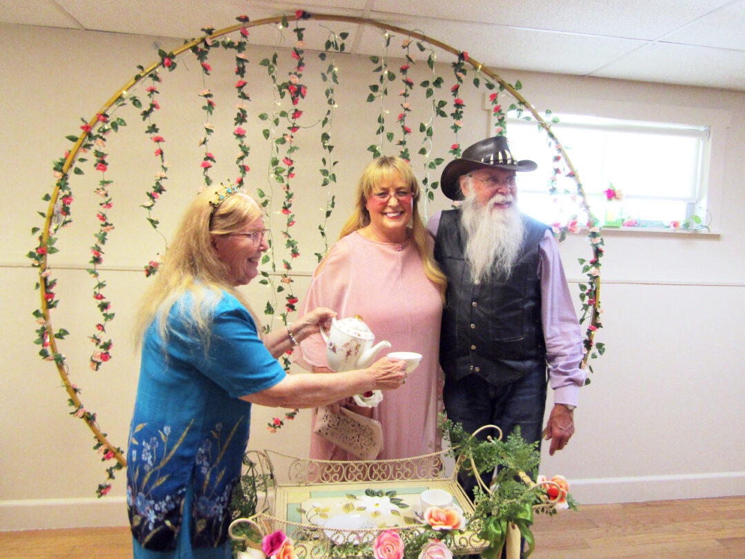 Pouring tea for Santa and Mrs. Clause who attended the tea and presented Leisure Shores with a new TV. (Photos by Rhea-Frances Tetley)