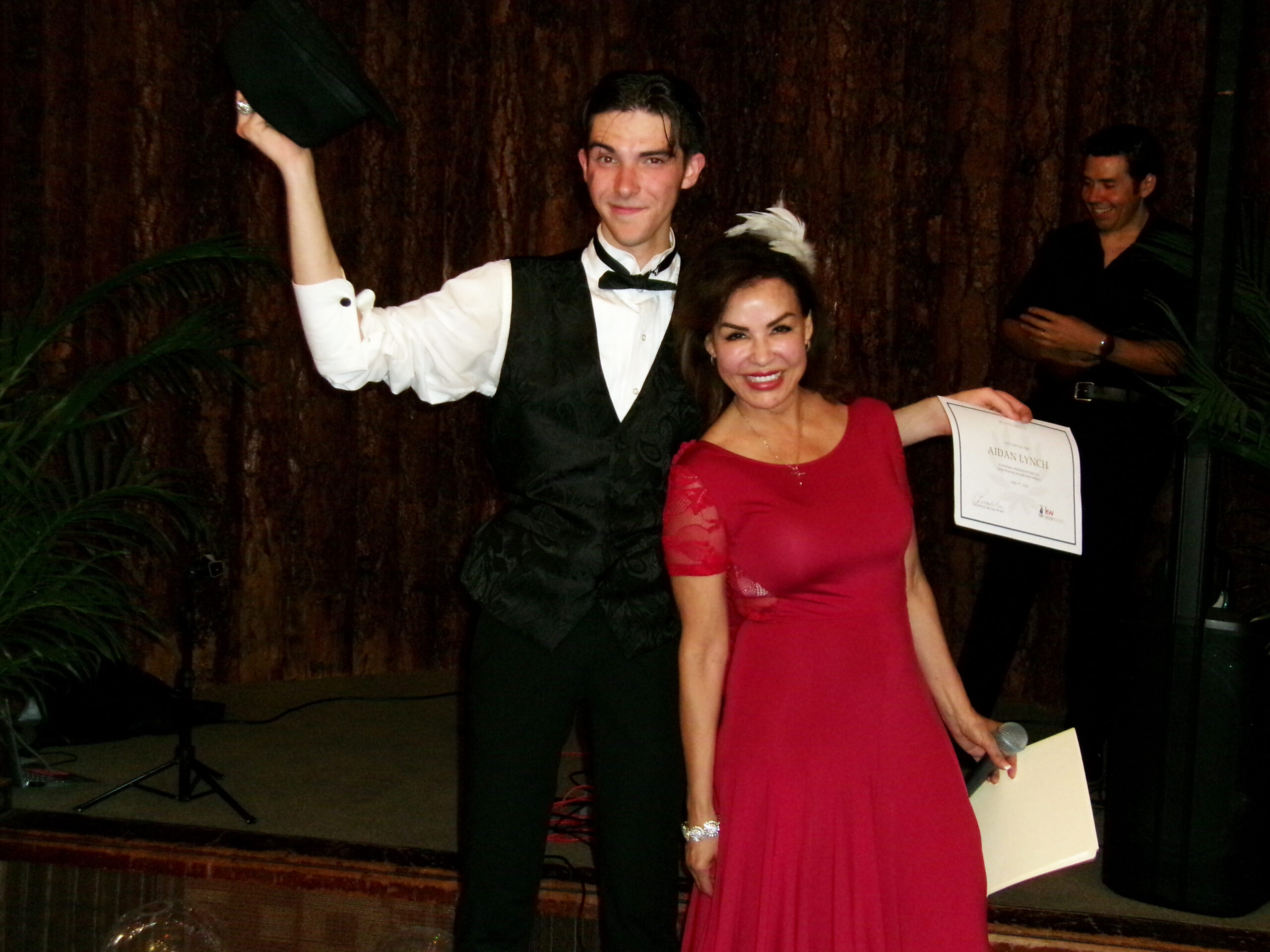 Cecilia Ponce De Leon presenting a scholarship certificate to Aidan Lynch. (Photos by Rhea-Frances Tetley)